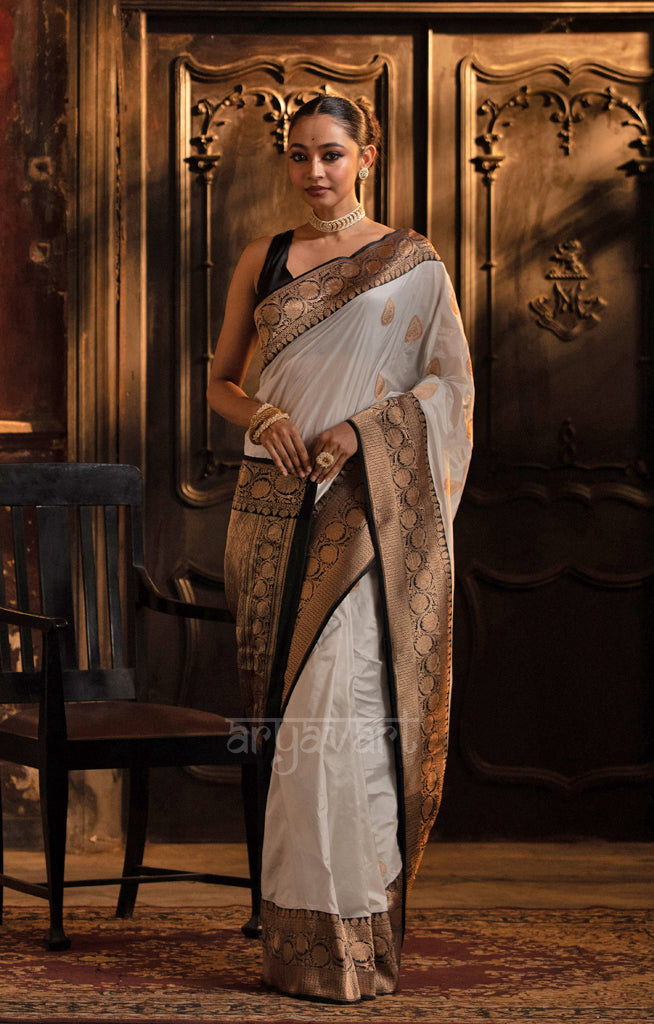 Striking White Katan Silk Saree With A Black Border & Gold Buttas